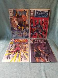 lot 59 image: Selection of 4 comic books - Ninjak, Shadow, Hard Corps, and Tomb Raider