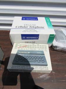 lot 35 image: Older Motorola Deluxe cell phone in original packing and 2nd edition Franklin Spelling keyboard