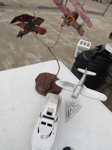 lot 203 image: boat on feet stand 7 long 6 tall,  silver plane trophy    & 2 metal plane art
