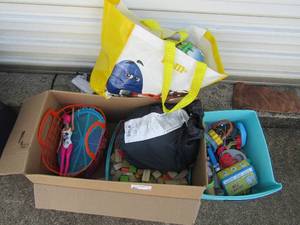 lot 25 image: Box full of toys- blocks, dolls, wooden train track in bag
