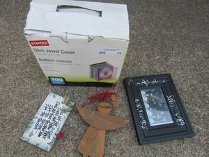 lot 24 image: Slim Jewel Case 100 cases each holds 1 disc, Black 5x7 frame 2 wooden art pieces