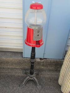 lot 248 image: GUM BALL MACHINE RED ON BLACK STAND 4 FEET  37 TALL