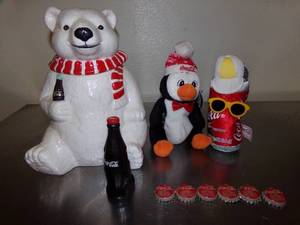 lot 46 image: Coca-Cola Polar Bear Cookie Jar, Stapler Penguin, Toy Soda Can, Sheet & Bottle Caps
