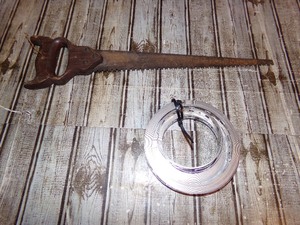 lot 240 image: Stainless Steel Hose Clamp Roll & Hand Saw