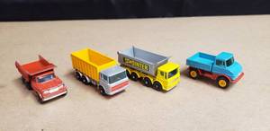 lot 121 image: Lot of 4 Vintage Matchbox Dump Trucks - Unimog No. 49, 8 Wheel Tipper No. 51, Tipper Container Truck No. 47, & Dumper Truck No. 48