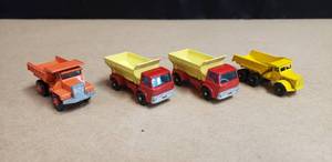 lot 122 image: Lot of 4 Vintage Matchbox Dump Trucks - Dump Truck No. 6, Grit-Spreading Truck No. 70, Grit-Spreading Truck No. 70, & Mack Dump Truck No.28