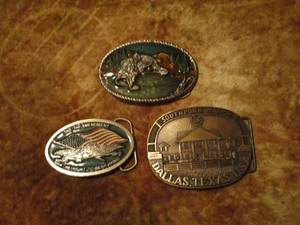 lot 27 image: SOLID BRASS SOUTHFORK RANCH DALLAS TM 1985 BELT BUCKLE.. BASS FISHING METAL BELT BUCKLE STAMPED 8569, 2ND AMENDMENT WITH AMERCAN FLAG AND EAGLE METAL BELT BUCKLE STAMPED 2238 ,&nbsp