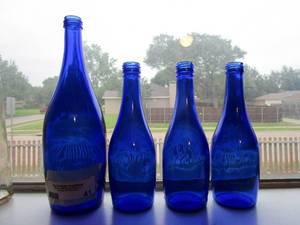 lot 41 image: SET OF 4 VINTAGE BLUE TY NANT SPRING GLASS BOTTLES