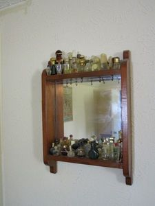 lot 158 image: WALL MOUNTED MIRROR W SHELF &amp HOOKS FOR JELEWRY, VINTAGE PERUMECOLOGNE BOTTLES INCL.