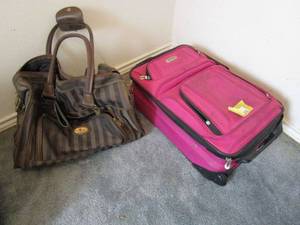 lot 215 image: DESTINATION TRAVEL BAG AND PINK STRATUS SUITCASE WITH WHEELS.