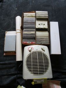 lot 223 image: BOX OF VINTAGE CASSETTE TAPES, SMALL SPACE HEATER, APPLE WATCH BANDS IN BOX WITH CHARGING CORD