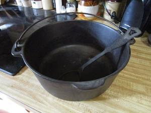 lot 232 image: CAST IRON POT WITH HANDLE AND CAST IRON SPOON