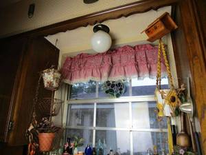 lot 265 image: HANGING DECOR AROUND KITCHEN WINDOW.... 3 TIER HANGING PLANT HOLDER, YELLO MACRAME PLANT HOLDER, WOODEN HANGING HOUSE, STAINED GLASS WINDOW DECOR, LADDLE WITH PLANT, STRAINER AND HAND JUICER.&nbsp