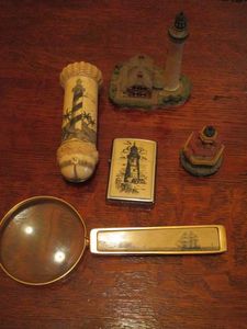 lot 182 image: SCRIMSHAWLIGHTHOUSE LOT, SCRIMSHAW CYLINDER CONTAINER W TOP THAT UNSCREWS, MAGNIFYING GLASS &amp LIGHTER W SCRIMSHAW ART, 2 LIGHTHOUSE REPLICAS