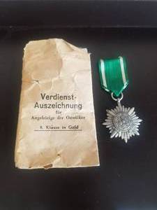 lot 50 image: WWII German decoration for Gallantry and Merit with swords - Eastern People, also envelope (reads Merit award members for of the Eastern Peoples)
