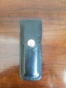 lot 87 image: Buck folding knife 110V with leather case