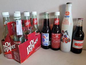 lot 38 image: VINTAGE DR. PEPPER COMMEMORATIVE BOTTLES WITH CARTON CARRIER AS SHOWN.