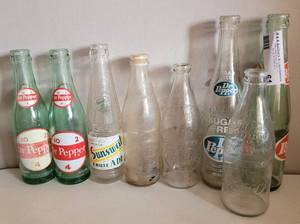 lot 61 image: VINTAGE SUNSWEET AND DR. PEPPER BOTTLES AS SHOWN.