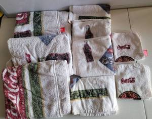 lot 152 image: LOT OF COCA-COLA THEMED BATH TOWELS IN ASSORTED SIZES AS SHOWN.