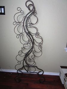 lot 99 image: TALL FREE STANDING METAL WINE BOTTLE RACK