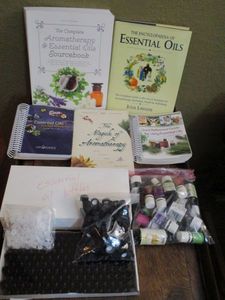 lot 268 image: ESSENTIAL OILS LOT- BAG OF ESSENTIAL OILS, BOX OF EMPTY BOTTLES WLIDS, BOOKS ON ESSENTIAL OILS