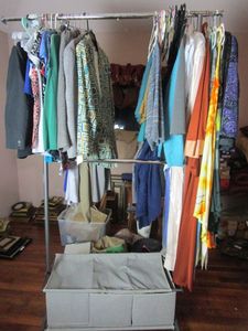 lot 301 image: ROLLING CLOTHING RACK DOUBLE BARRED WITH STORAGE, CONTENTS NOT INCLUDED.