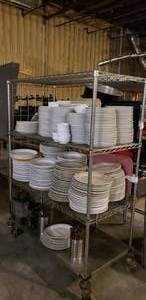 lot 47 image: Large Quantity of Plates, Utensils & More.  Shelf is Included.