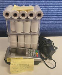 lot 194 image: VERIFONE VX680 MOBILE WIRELESS POS TERMINAL WITH POWER CORD AND TAPEROLLS AS SHOWN.