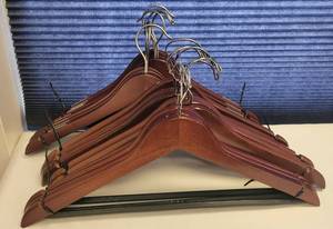 lot 239 image: LOT OF WOODEN CLOTHES HANGERS IN STYLE SHOWN.