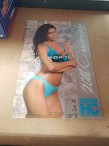 lot 45 image: Hooters 20th Anniversary Calander with Signatures.  This came from Walter Reed Hospital when some of the girls came and visited with the injured soldiers.