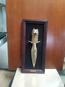 lot 65 image: TimberWolf head dagger (16) on framed holder (10by22)