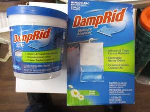 lot 145 image: 2- Damp Rid Moisture Absorber- 1-10.5 Oz Tub and 1-Pack, Hanging Bag, Note 2-X Money
