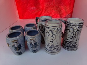 lot 125 image: Three 3 Beer Steins wFour 2 Shot GlassesToothpick Holders Decorated wMan Holding Beer Stein