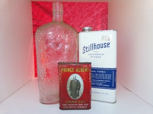lot 129 image: 4.5 Price Albert Metal Tobacco Can, 10.5 Garretts American Wine Bottle, 8 Can of Stillhouse Americas Finest Classic Vodka