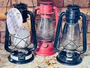 lot 153 image: Two Black 12 Weather Rite Outdoor Kerosene Lantern and One Red&nbsp