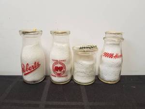 lot 131 image: Selection of 4 vintage glass milk bottles - Roberts, AMP, Harmony, dairies, and Your Host Restaurants