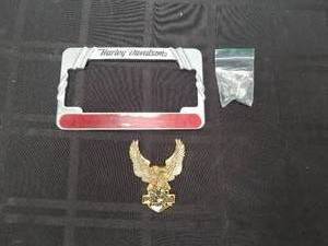 lot 122 image: Harley Davidson metal license plate cover and a gold metal badge