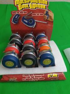 lot 25 image: MULTIFUNCTION 3 TOOL TORCH LIGHTER (12 LIGHTERS IN COUNTER TOP  DISPLAY) INCLUDES BUILT IN TAPE MEASURE, FLAT HEAD SCREW DRIVER, PHILIP HEAD SCREW DRIVER