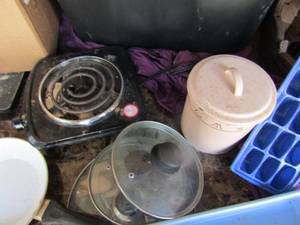 lot 106 image: Black tub full of- dishes, pans, lids, flatwear, 1 burner cooker and more