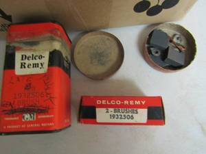 lot 69 image: Box of Delco remy brush sets # T857963 & delco remy brushes #1932506 & metal ten cans of delco remy brushes # 1932506A