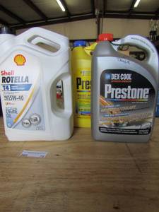 lot 79 image: 2 opened bottles of Rotella motor oil 15w-40 and 2 prestone coolant opened