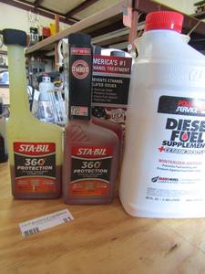 lot 81 image: 4 bottles of Sta-bil ethenal gas treatment opened and Opened jug of diesel fuel supplement