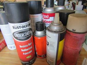 lot 99 image: Rust cleaner, slime tire repair, brake cleaner, starter fluid and more all opened