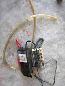 lot 217 image: Uniden transmitter and travel size battery load tester