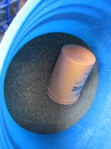 lot 290 image: Blue 5 gallon bucket half full of ant killer