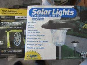 lot 292 image: 2 solar lights and tire bonnet tie down with ratchet