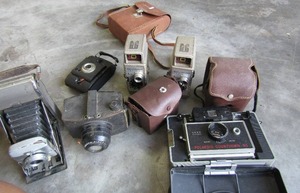 lot 330 image: Antique bell & Howell camera, Polaroid countdown, 2 flash lenses and more
