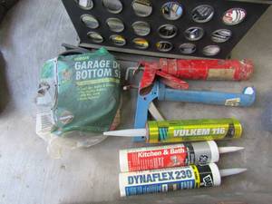 lot 335 image: Black crate full of caulking & guns, welding rods