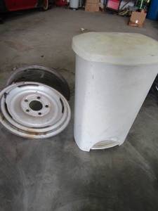 lot 767 image: 15 tire rim,  trash can full of shop rags