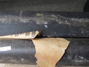 lot 935 image: 1 roll of tar paper 2 rolls of roofing material